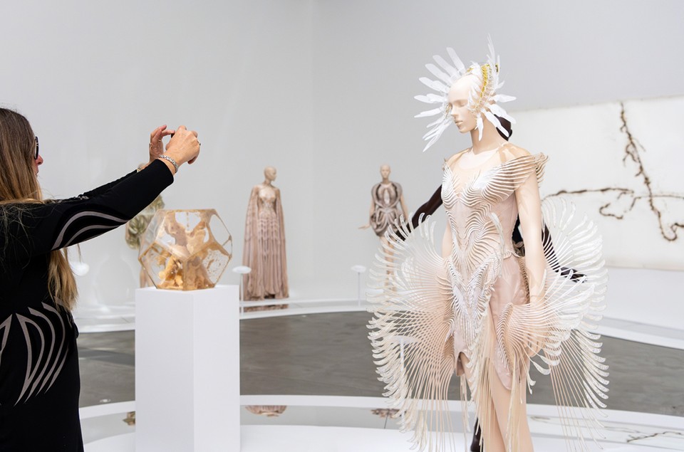 A lady taking a photo of an art display at QAGOMA, Brisbane.